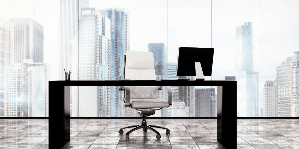 Image of open desk at a nonprofit office waiting for a new chief development officers to be hired. Text can be seen that asks if you want to hire and request development leadership.